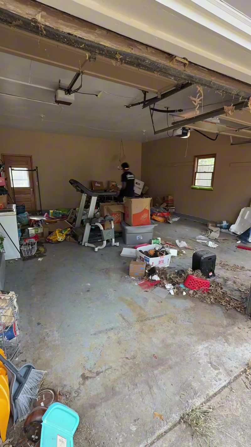 Declutter crew clearing out a two-car garage during a property cleanout