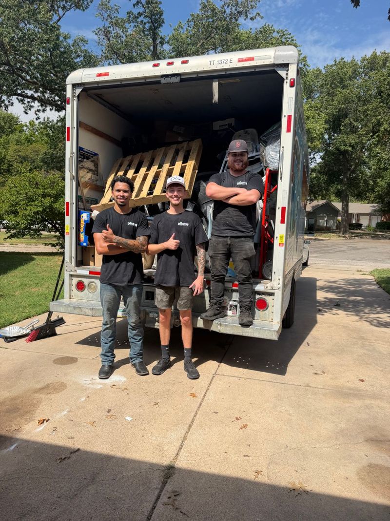 The Declutter crew giving a thumbs up in front of a fully loaded box truck after a Wichita cleanout