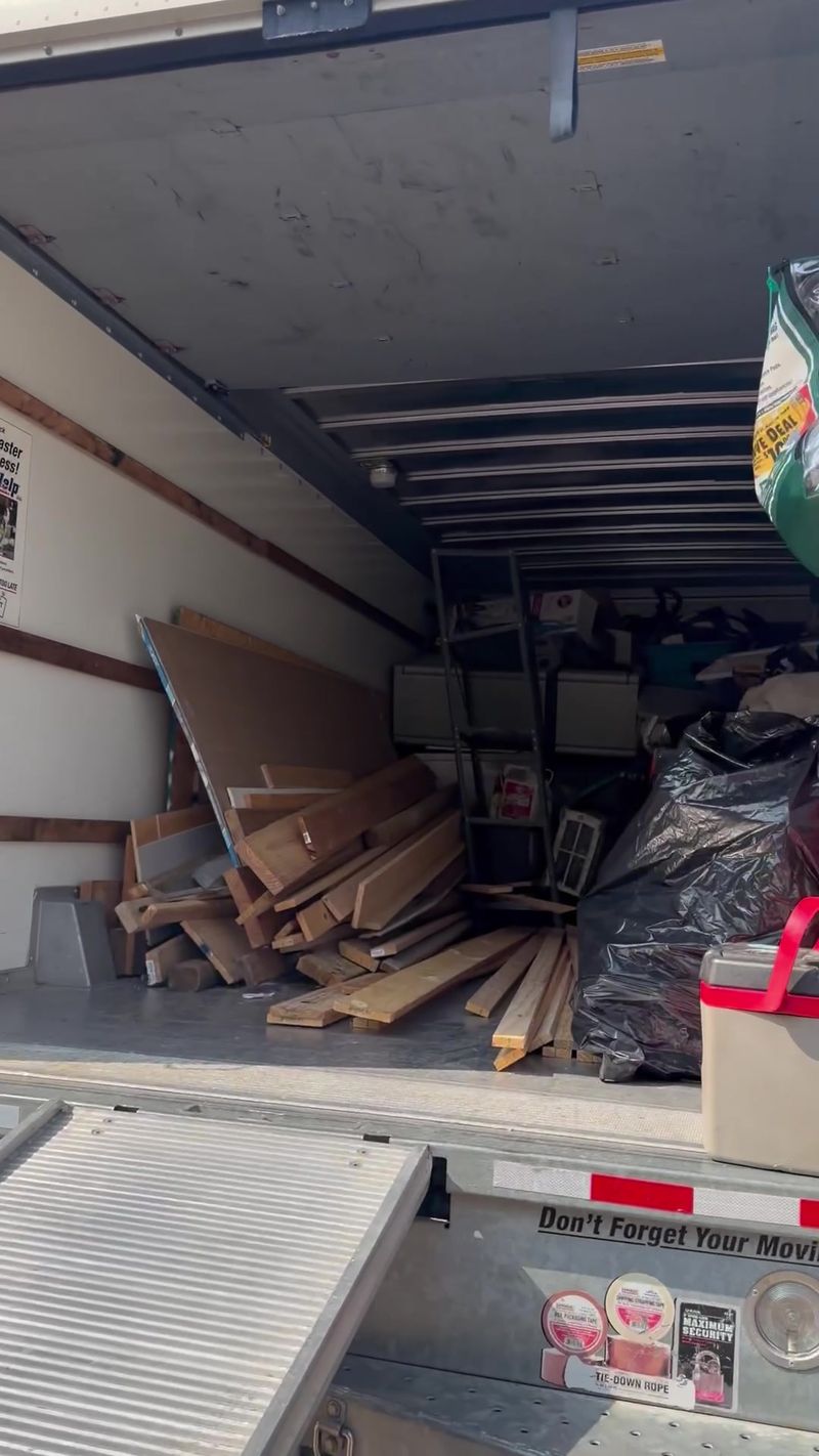 A Declutter trailer loaded with lumber, boxes and bags from a cleanout