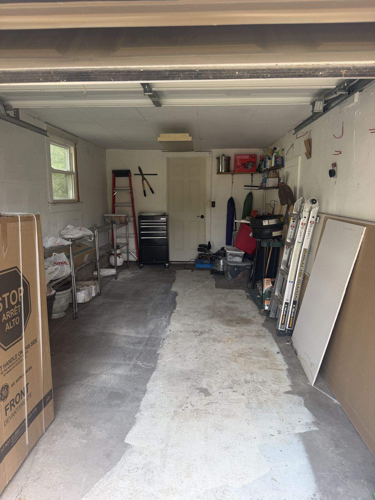 A single-car garage in Wichita after a Declutter cleanout, floor cleared and swept